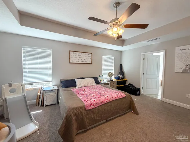 a bedroom with a bed couch and window