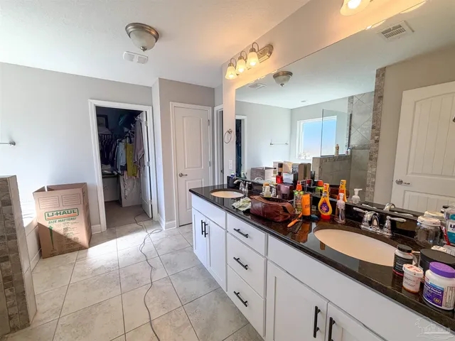 a large kitchen with a lot of cabinets and wooden floor