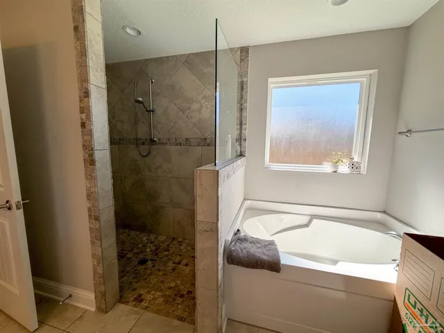 a bathroom with a tub and shower