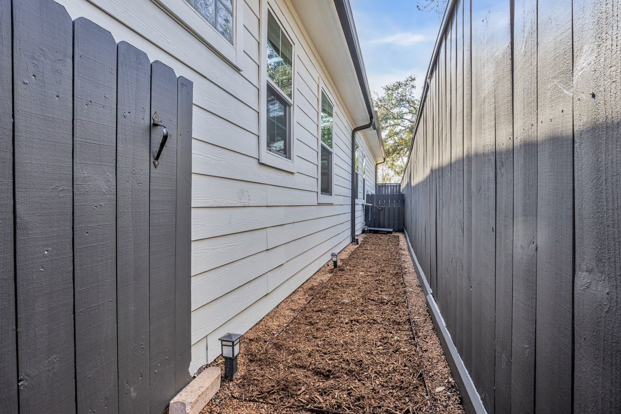 4702 Lido Lane Houston, TX 77092 - Photo 38 of 38 West side yard - DOG RUN! Your best friend can exit the house through the laundry room's sweet doggie door and be safe within his own little fenced yard!