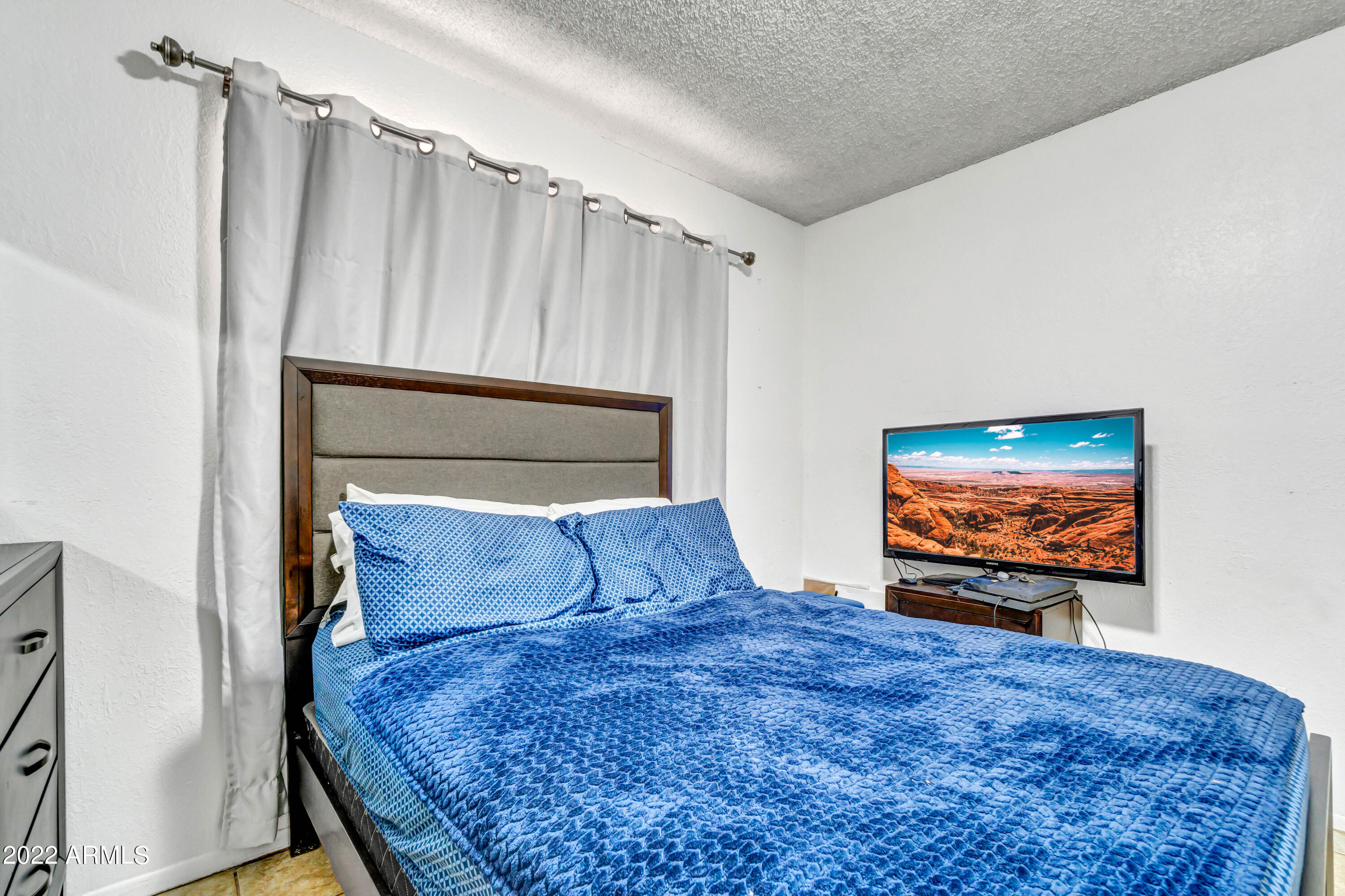 2011 West Pecan Road Phoenix, AZ 85041 - Photo 18 of 25 a bedroom with a bed and a flat screen tv