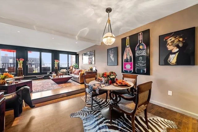 a living room with furniture and a chandelier