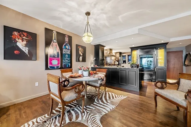a living room with furniture a flat screen tv and kitchen view