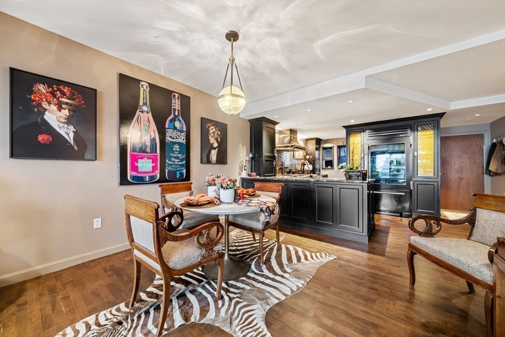 220 Commercial Street, Unit 5A Boston, MA 02109 - Photo 12 of 37 a living room with furniture a flat screen tv and kitchen view