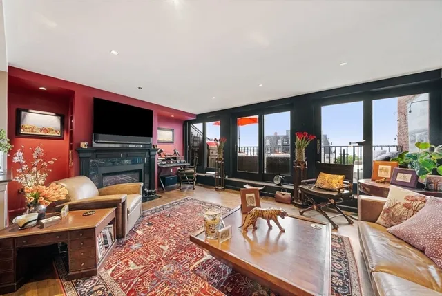 a living room with furniture a flat screen tv and a large window