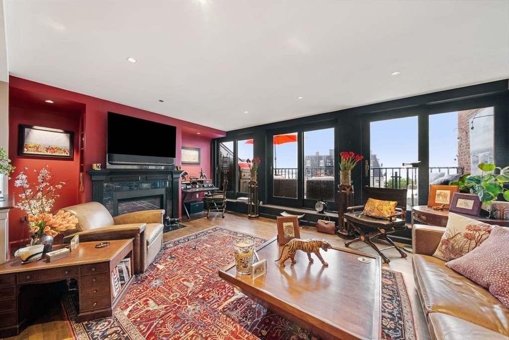 220 Commercial Street, Unit 5A Boston, MA 02109 - Photo 13 of 37 a living room with furniture a flat screen tv and a large window
