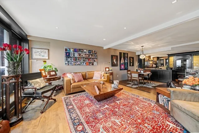 a living room with furniture hard wood floor and a flat screen tv