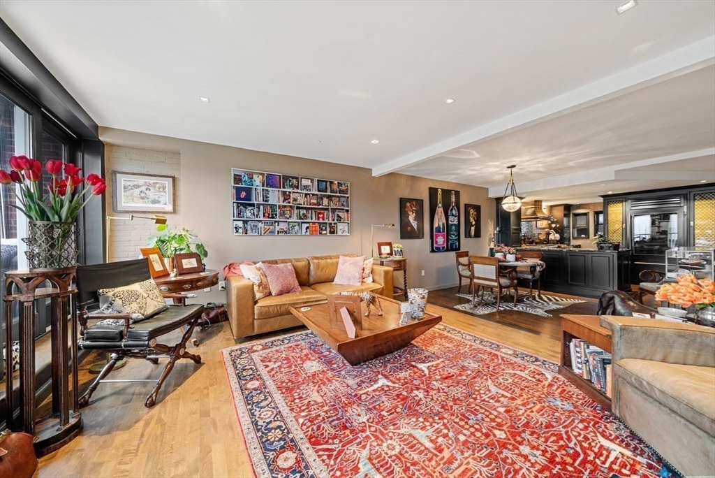 220 Commercial Street, Unit 5A Boston, MA 02109 - Photo 14 of 37 a living room with furniture hard wood floor and a flat screen tv