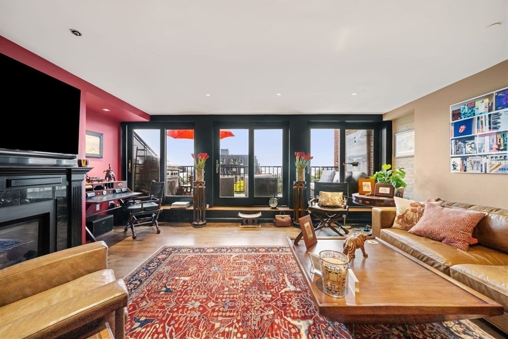 220 Commercial Street, Unit 5A Boston, MA 02109 - Photo 16 of 37 a living room with furniture flat screen tv and a large window