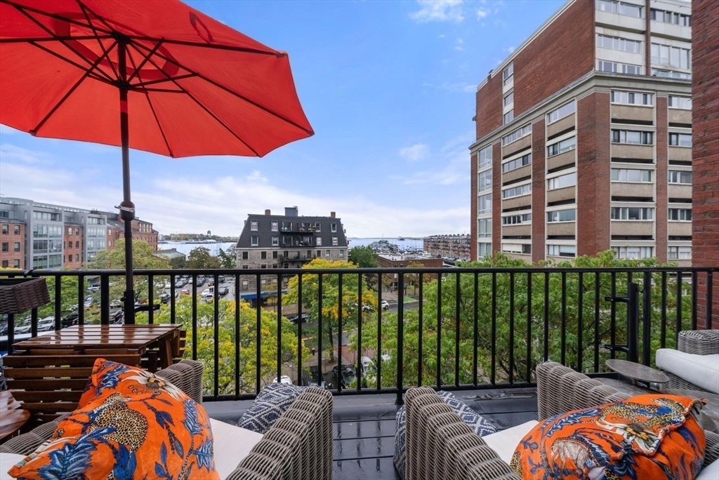 220 Commercial Street, Unit 5A Boston, MA 02109 - Photo 18 of 37 a balcony with furniture and umbrella
