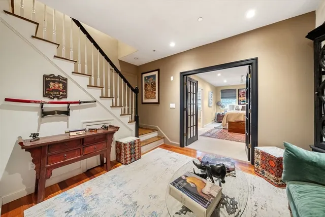 a bedroom with furniture and a wooden floor