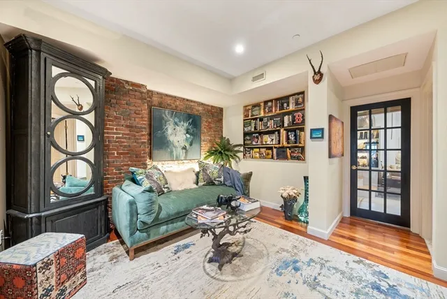 a living room with furniture window and wooden floor