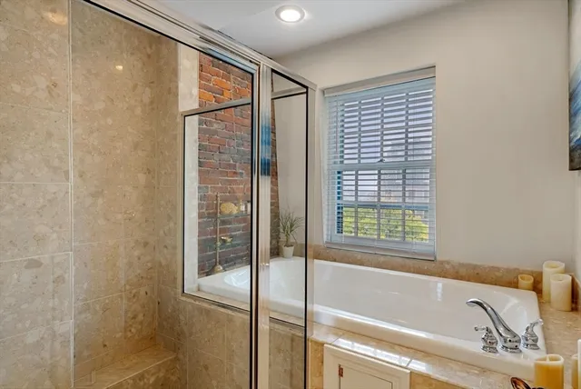a bathroom with a bathtub and a shower