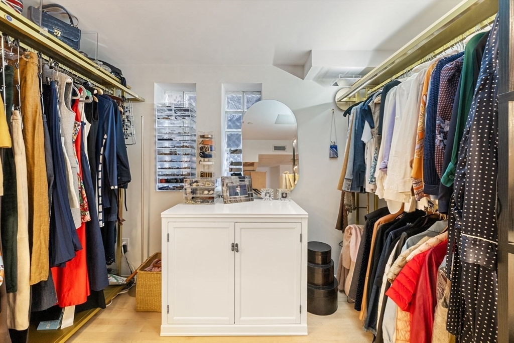 220 Commercial Street, Unit 5A Boston, MA 02109 - Photo 31 of 37 a view of walk in closet with clothes and shoes