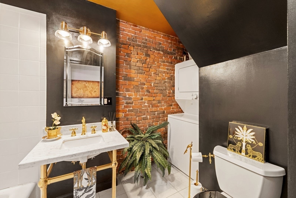 220 Commercial Street, Unit 5A Boston, MA 02109 - Photo 32 of 37 a bathroom with a toilet a sink and mirror