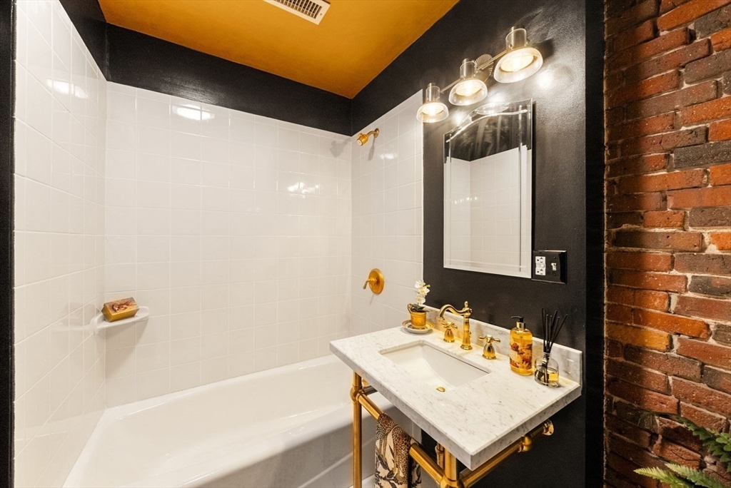 220 Commercial Street, Unit 5A Boston, MA 02109 - Photo 33 of 37 a bathroom with a sink and a mirror