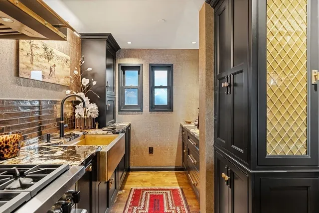 a view of a kitchen with a sink and cabinets