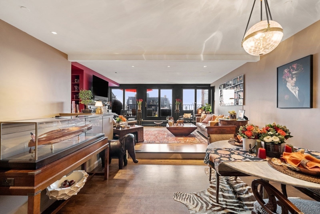220 Commercial Street, Unit 5A Boston, MA 02109 - Photo 9 of 37 a living room with lots of furniture and a chandelier