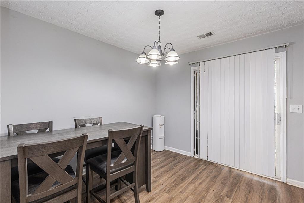 6536 Arbor Gate Drive Southwest, Unit 2 Mableton, GA 30126 - Photo 7 of 27 a view of a dining room with furniture and chandelier