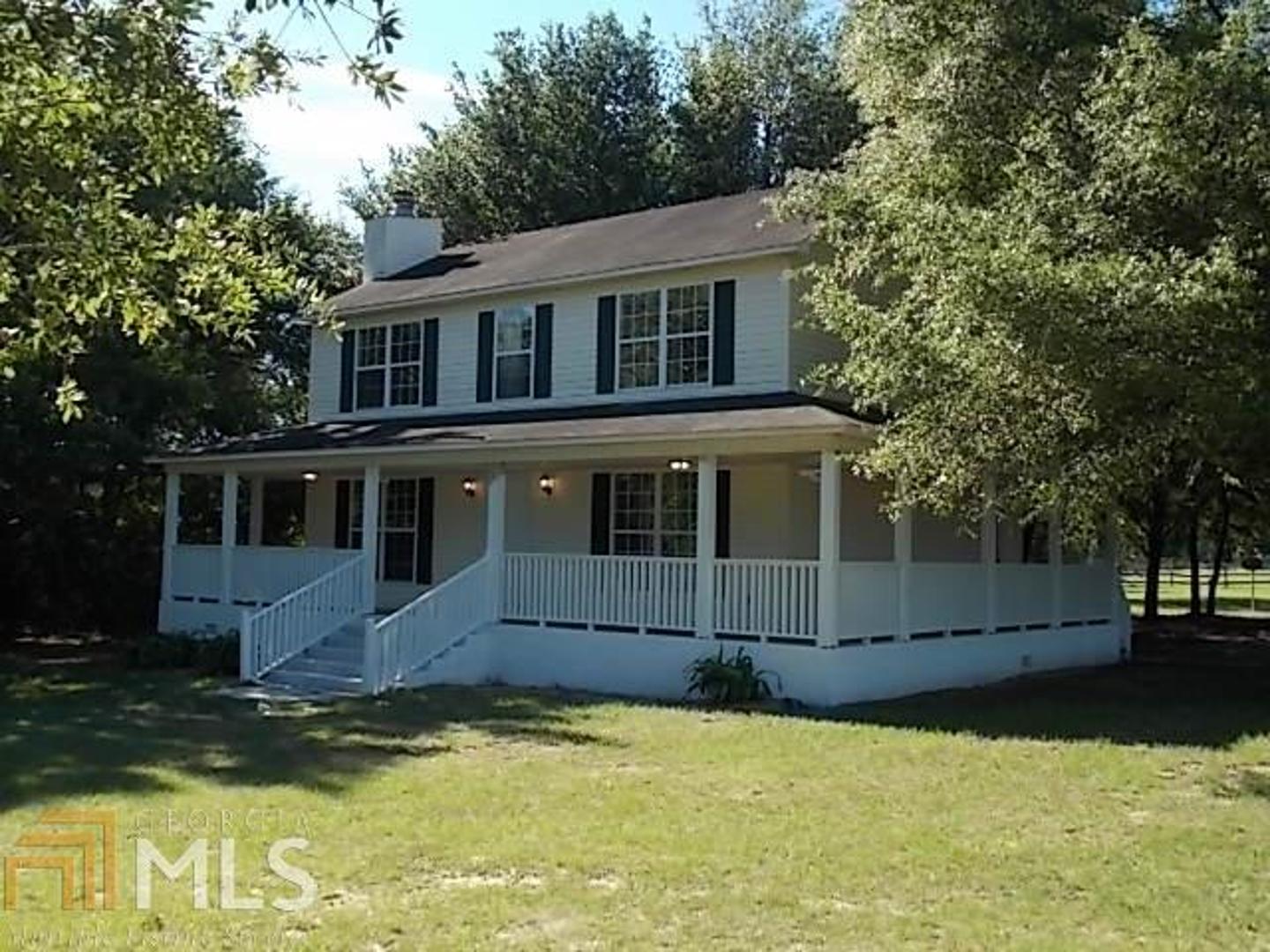 a front view of house with yard and trees