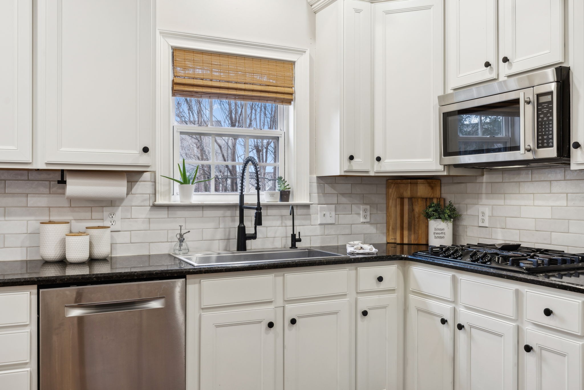 1209 White Rock Road Spring Hill, TN 37174 - Photo 25 of 93 a kitchen with granite countertop white cabinets and white appliances