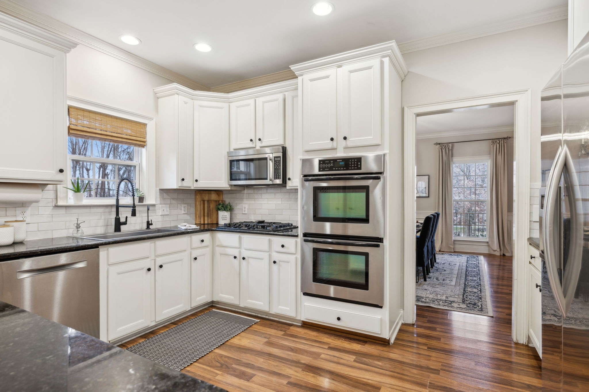 1209 White Rock Road Spring Hill, TN 37174 - Photo 26 of 93 a kitchen with stainless steel appliances granite countertop a refrigerator a stove top oven a sink and dishwasher with wooden floor