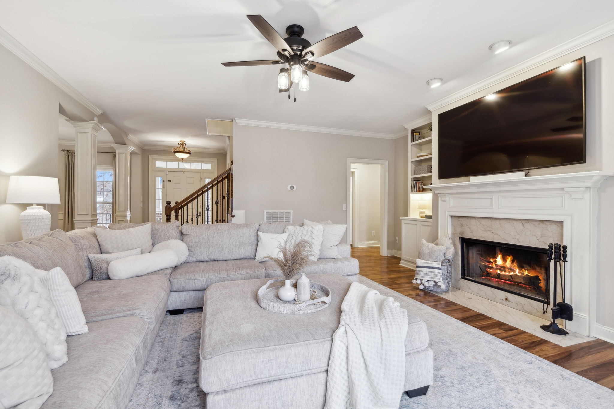 1209 White Rock Road Spring Hill, TN 37174 - Photo 5 of 93 a living room with furniture a flat screen tv and a fireplace