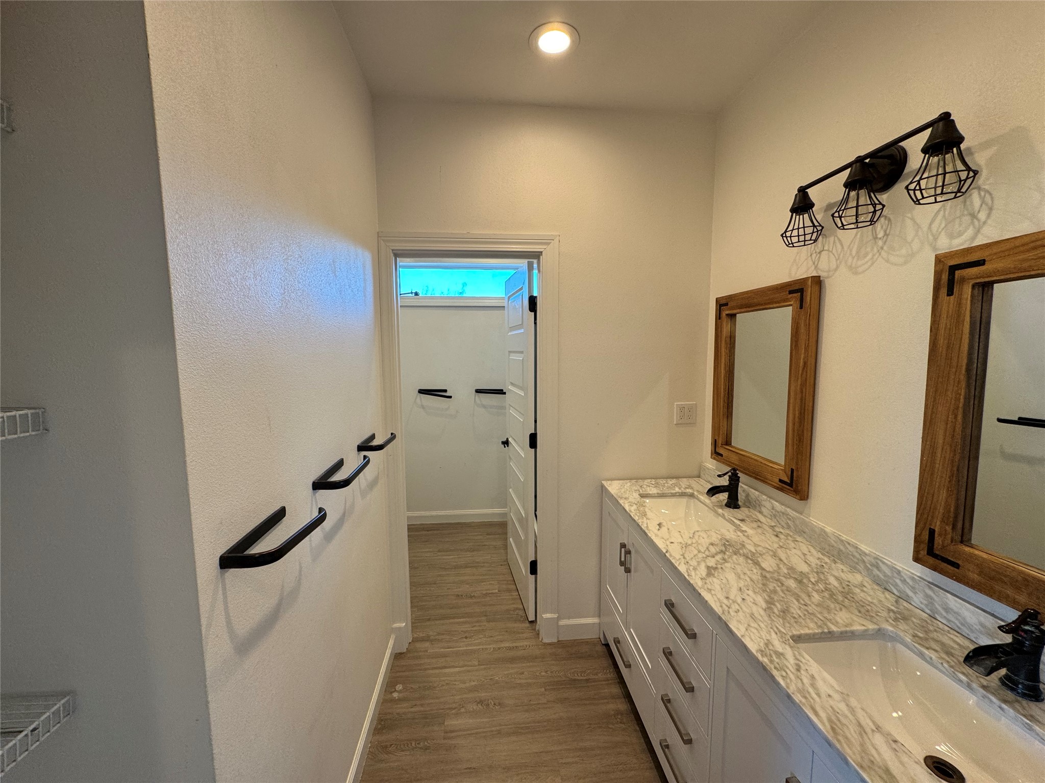 3633 Outback Trail Spicewood, TX 78669 - Photo 29 of 34 Bathroom featuring double vanity and dark wood finished floors