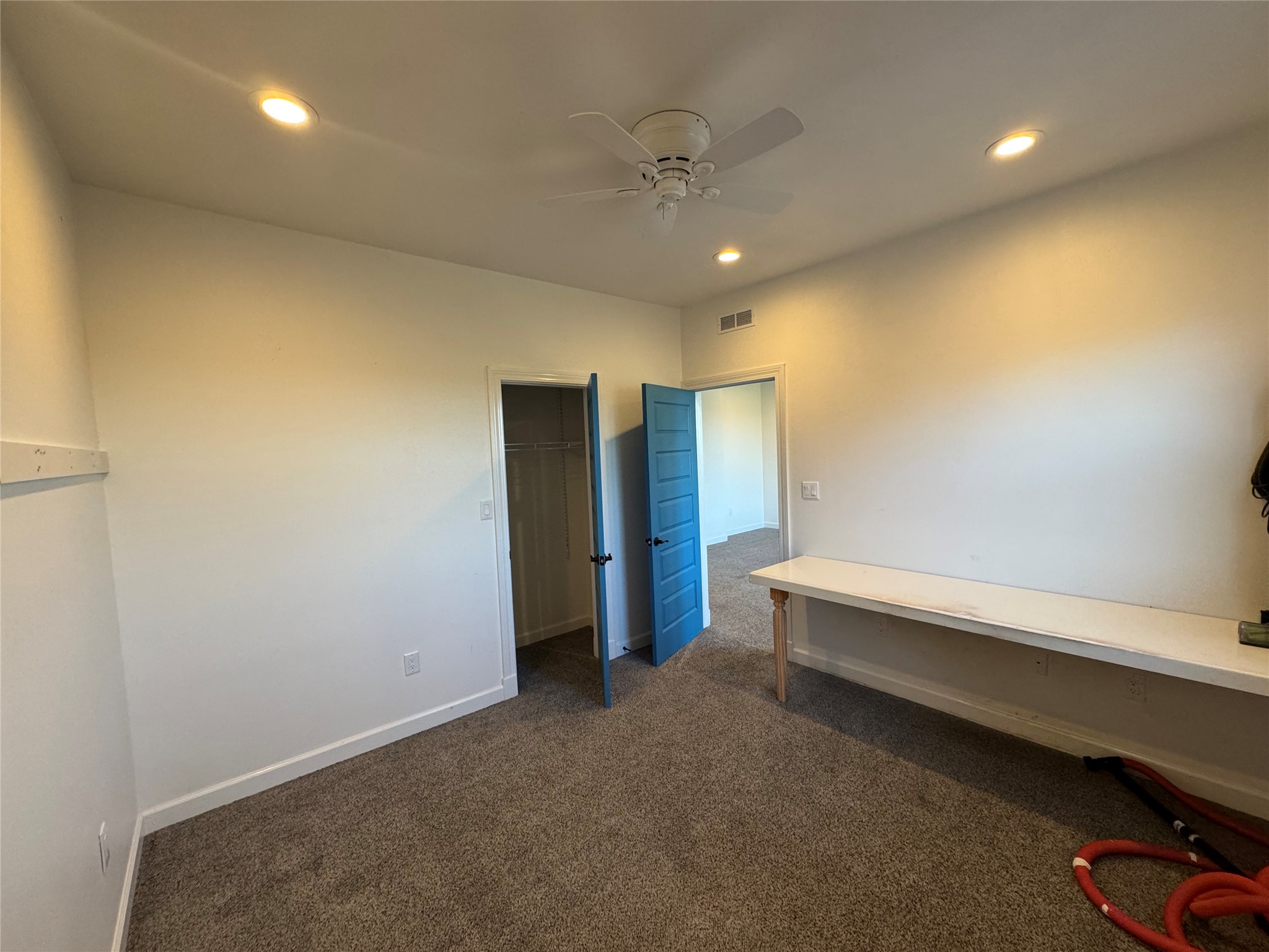 3633 Outback Trail Spicewood, TX 78669 - Photo 31 of 34 Bedroom with a ceiling fan, dark carpet, and recessed lighting