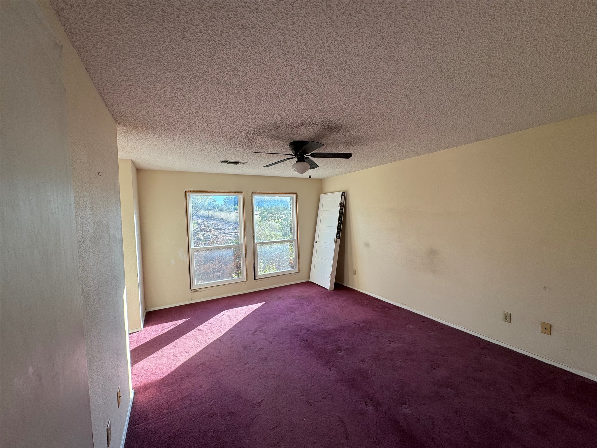 3633 Outback Trail Spicewood, TX 78669 - Photo 34 of 34 Spare room with carpet flooring, a textured ceiling, and a ceiling fan