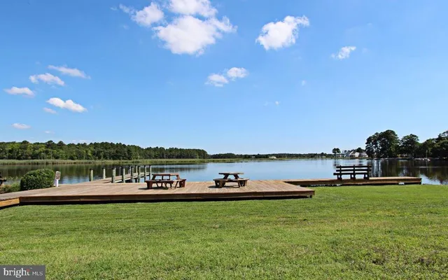 a roof deck with table and chairs under an umbrella