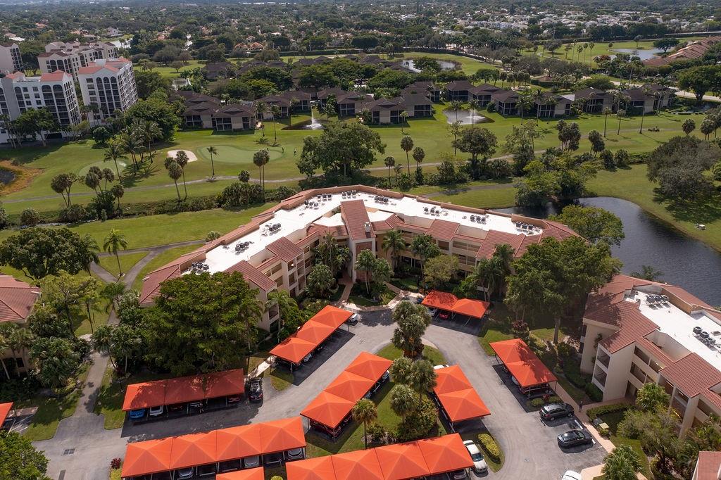 7520 La Paz Court, Unit 209 Boca Raton, FL 33433 - Photo 12 of 55 an aerial view of residential houses with outdoor space and swimming pool