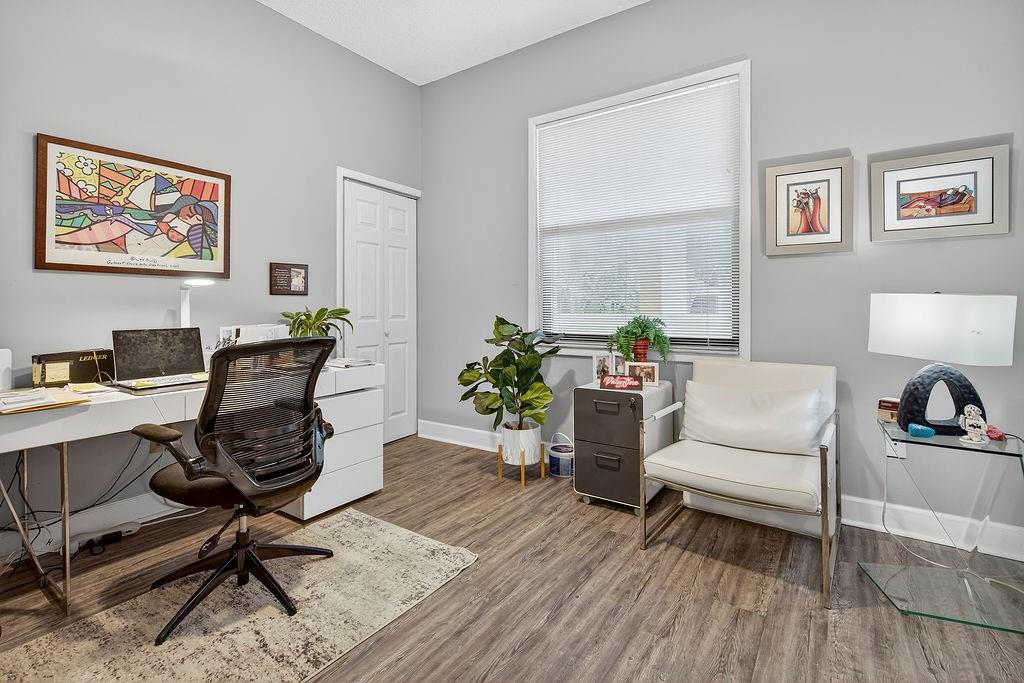 7520 La Paz Court, Unit 209 Boca Raton, FL 33433 - Photo 27 of 55 a workspace with furniture and a wooden floor