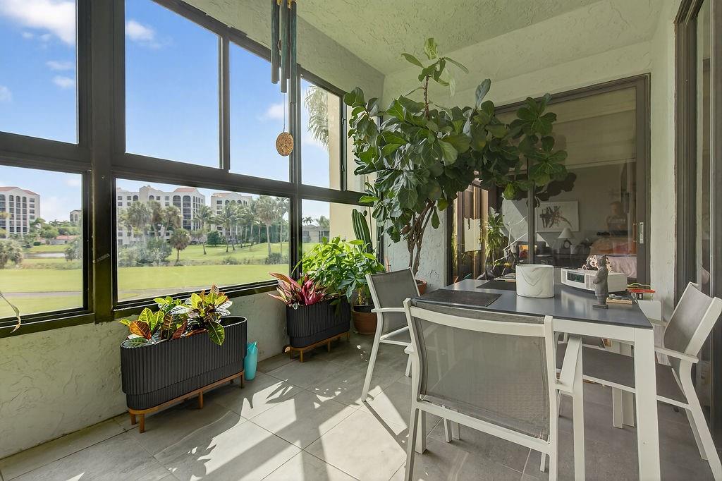 7520 La Paz Court, Unit 209 Boca Raton, FL 33433 - Photo 34 of 55 a room with furniture and a large window