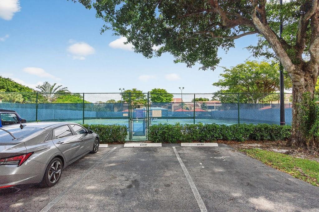 7520 La Paz Court, Unit 209 Boca Raton, FL 33433 - Photo 47 of 55 a view of a yard with car parked