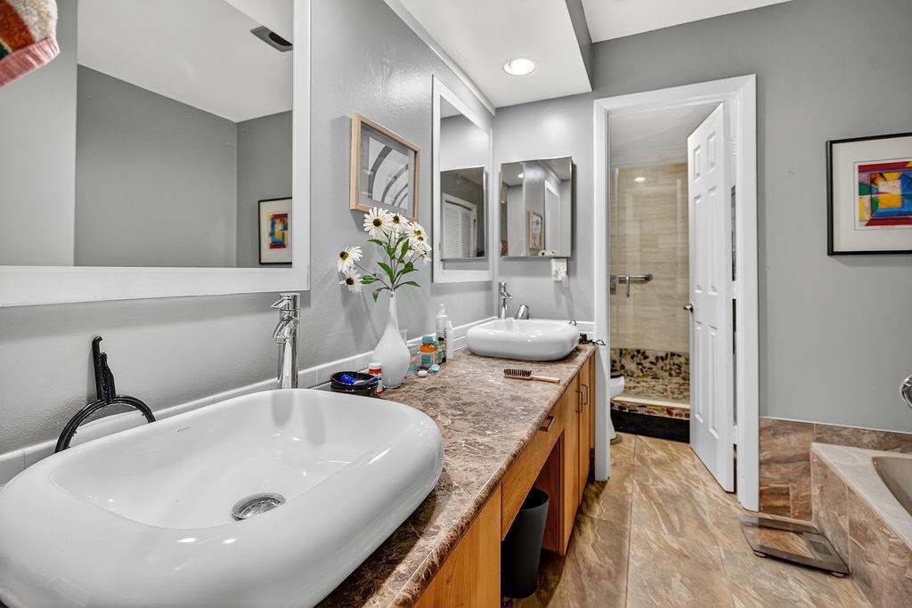 7520 La Paz Court, Unit 209 Boca Raton, FL 33433 - Photo 7 of 55 a en suite bathroom with a granite countertop tub and a sink