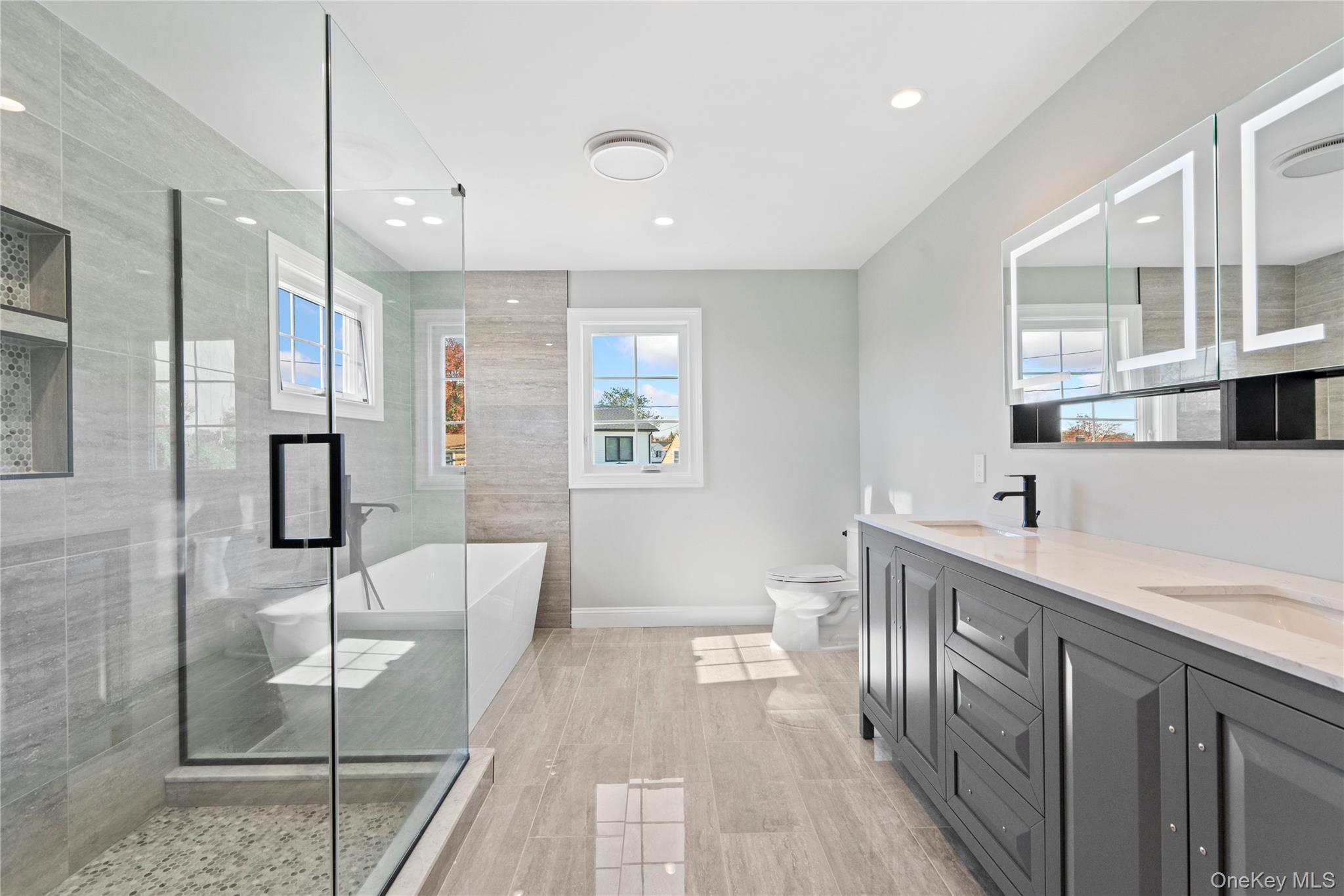 30 Virginia Road Syosset, NY 11791 - Photo 19 of 24 a spacious bathroom with a double vanity sink a mirror and a shower