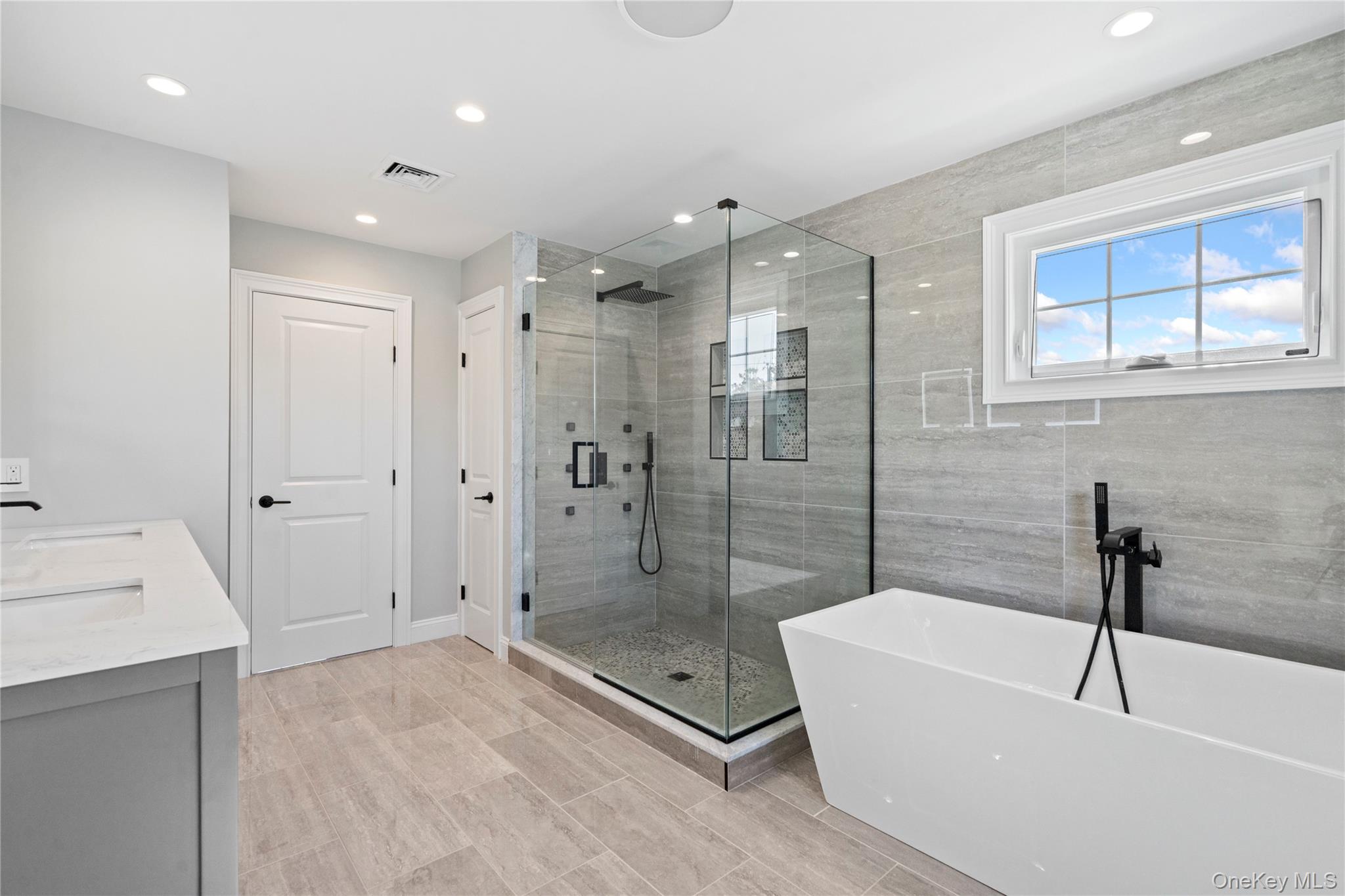 30 Virginia Road Syosset, NY 11791 - Photo 20 of 24 a bathroom with a bathtub and a shower