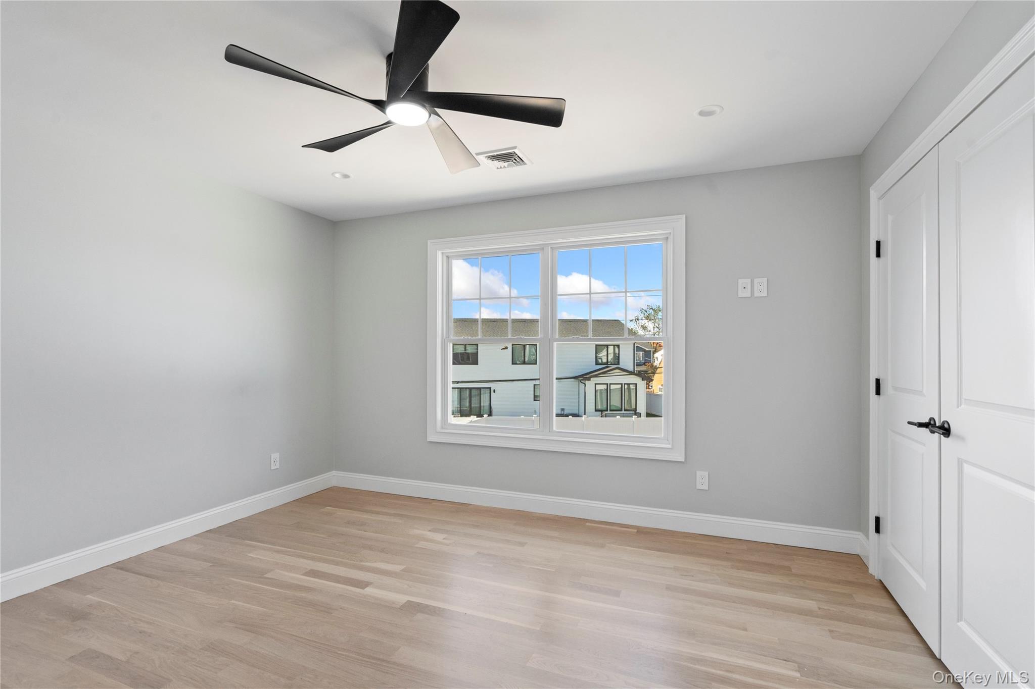 30 Virginia Road Syosset, NY 11791 - Photo 21 of 24 wooden floor in an empty room with a window
