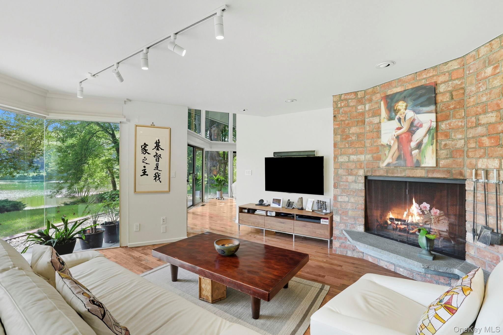 67 Banksville Road Armonk, NY 10504 - Photo 11 of 49 a living room with furniture a fireplace and a flat screen tv