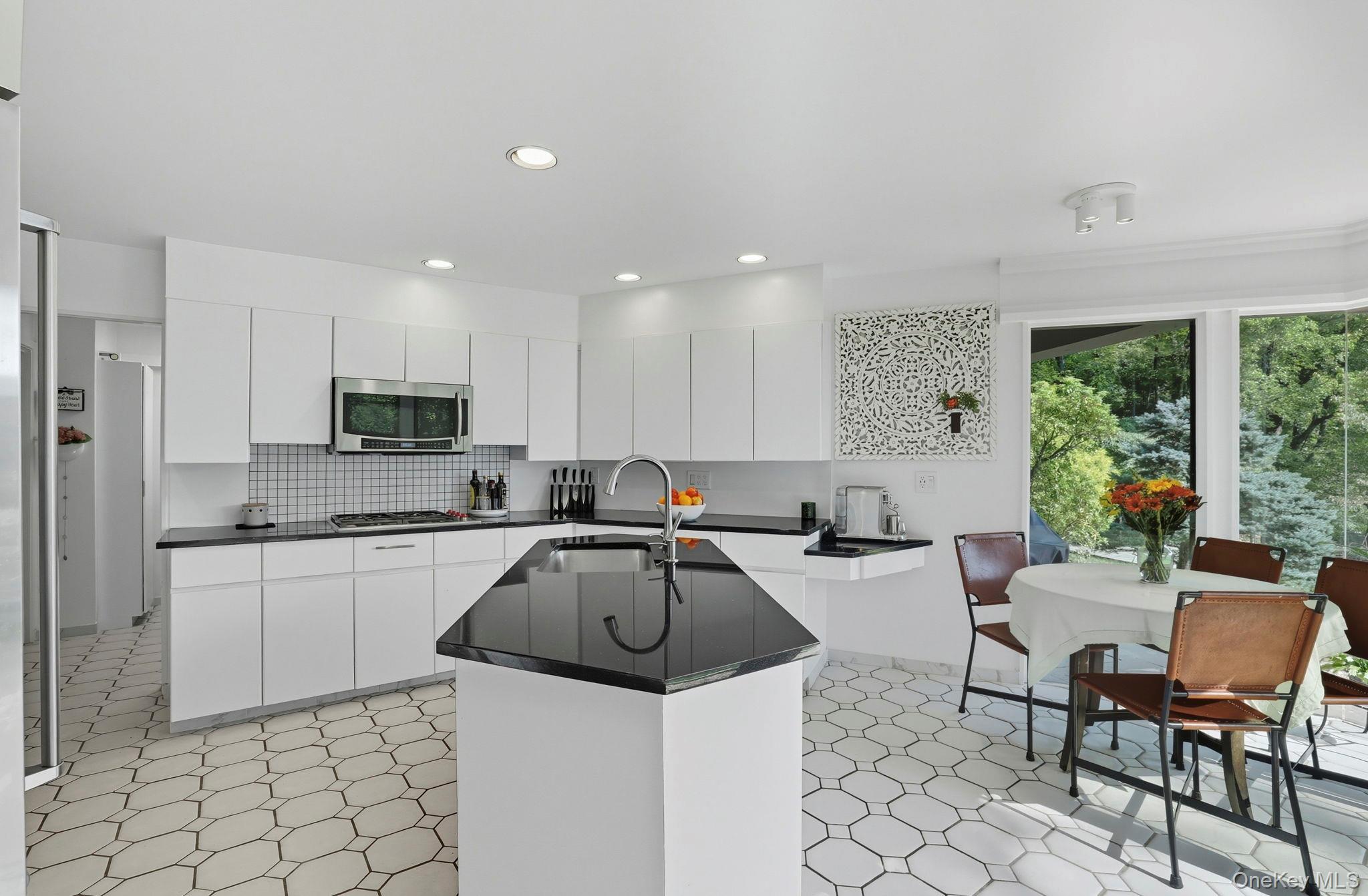67 Banksville Road Armonk, NY 10504 - Photo 18 of 49 a kitchen with stainless steel appliances kitchen island granite countertop a sink and cabinets