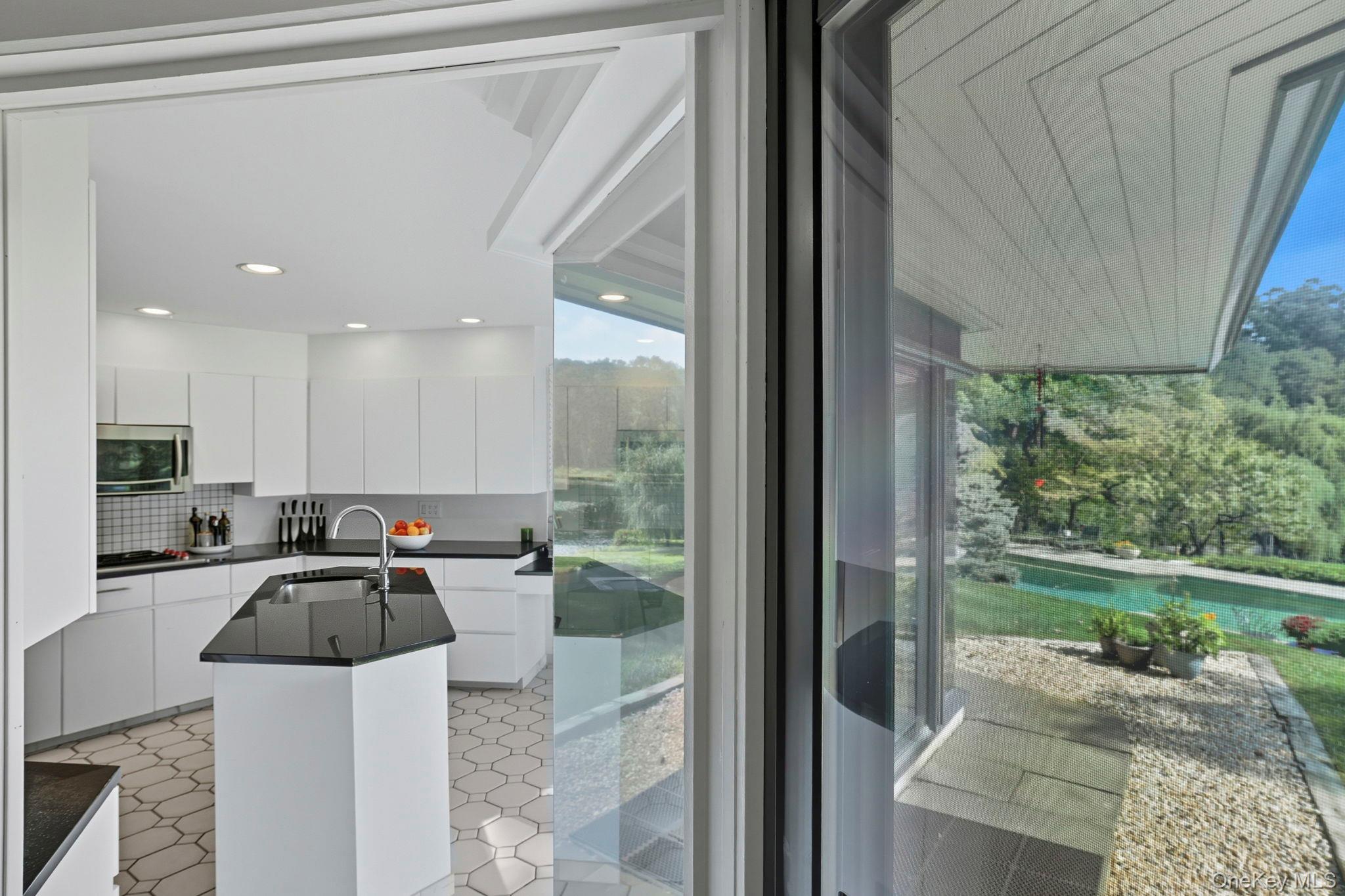 67 Banksville Road Armonk, NY 10504 - Photo 20 of 49 a kitchen with granite countertop a sink and a stove top oven