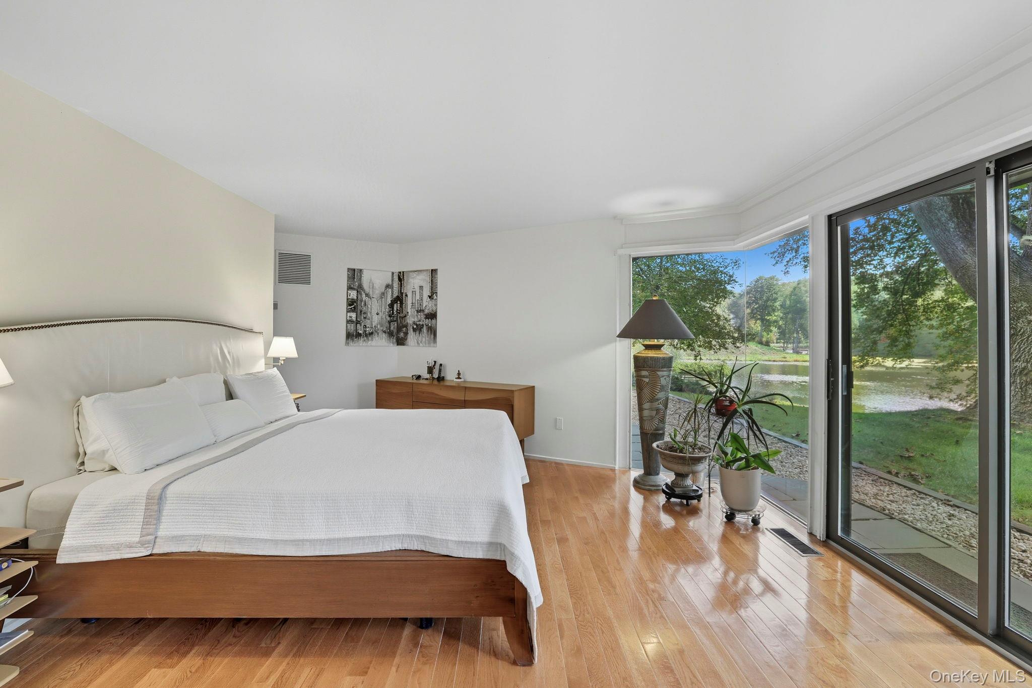 67 Banksville Road Armonk, NY 10504 - Photo 25 of 49 a bedroom with a bed and a large window with outer view