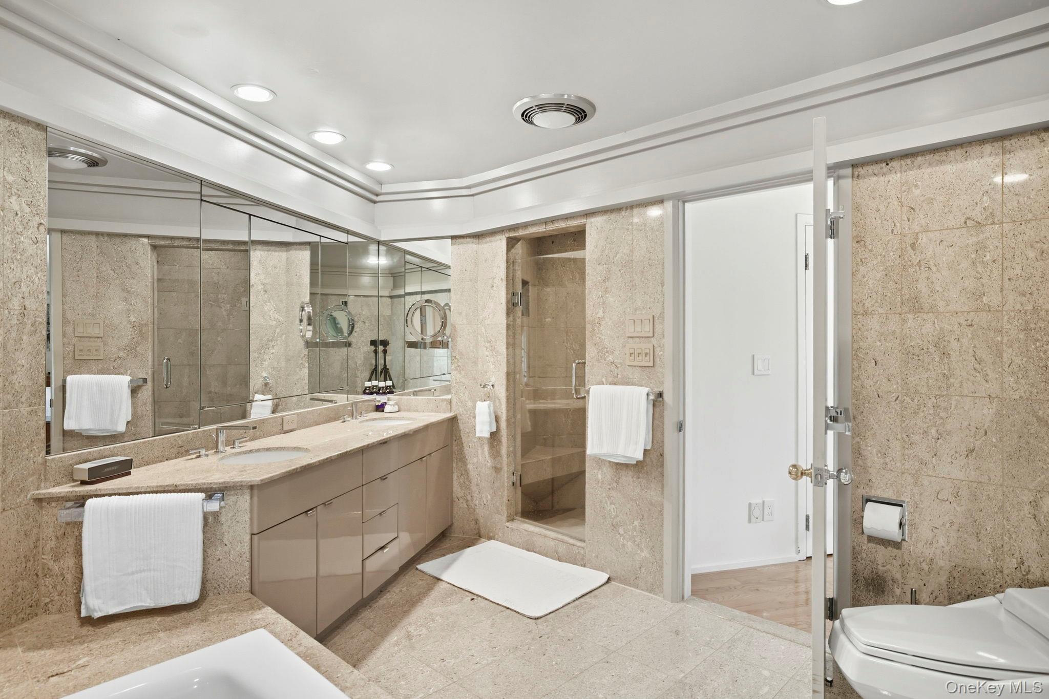 67 Banksville Road Armonk, NY 10504 - Photo 27 of 49 a bathroom with a double vanity sink toilet and shower