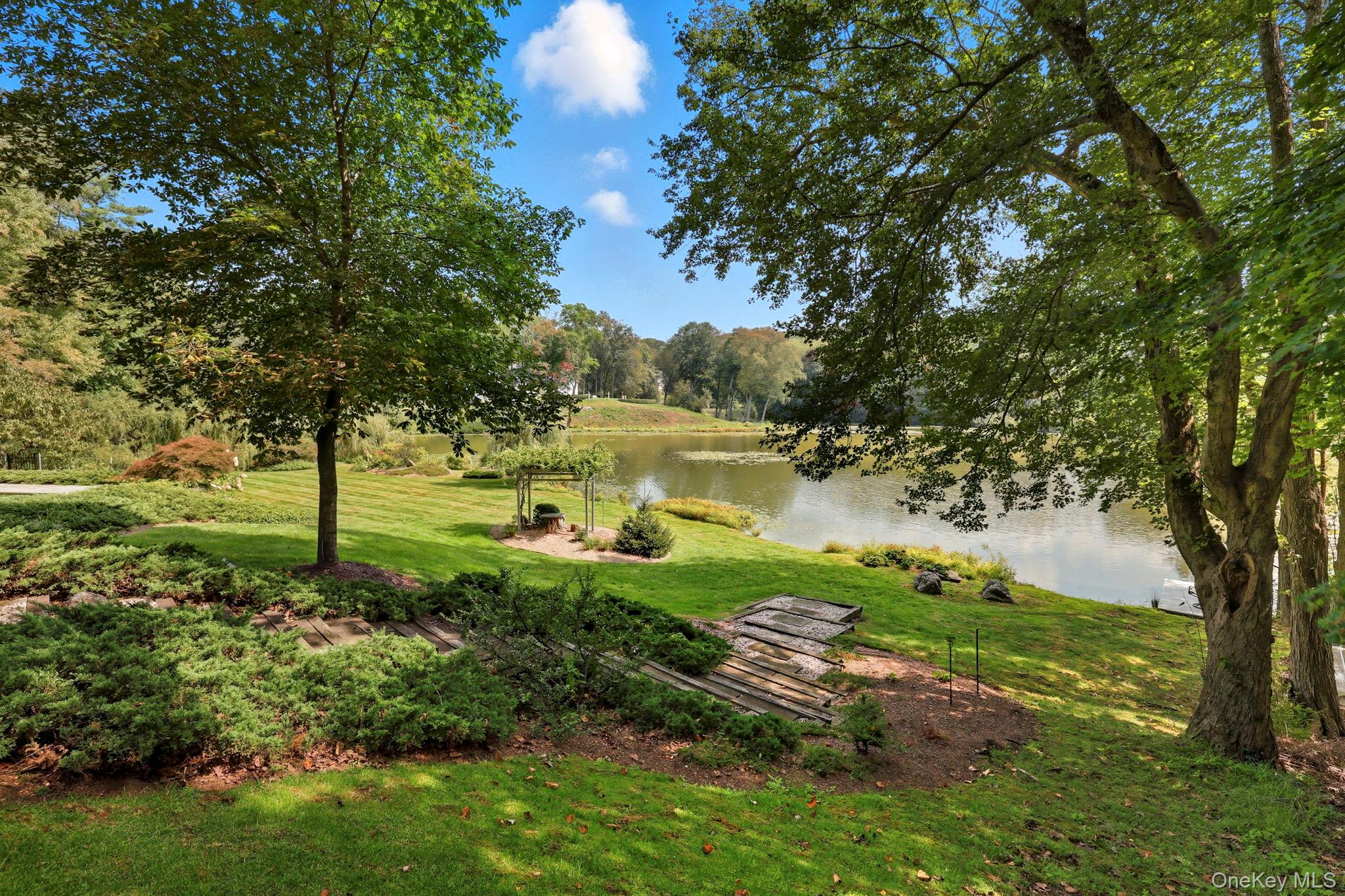 67 Banksville Road Armonk, NY 10504 - Photo 40 of 49 a view of a garden with a tree