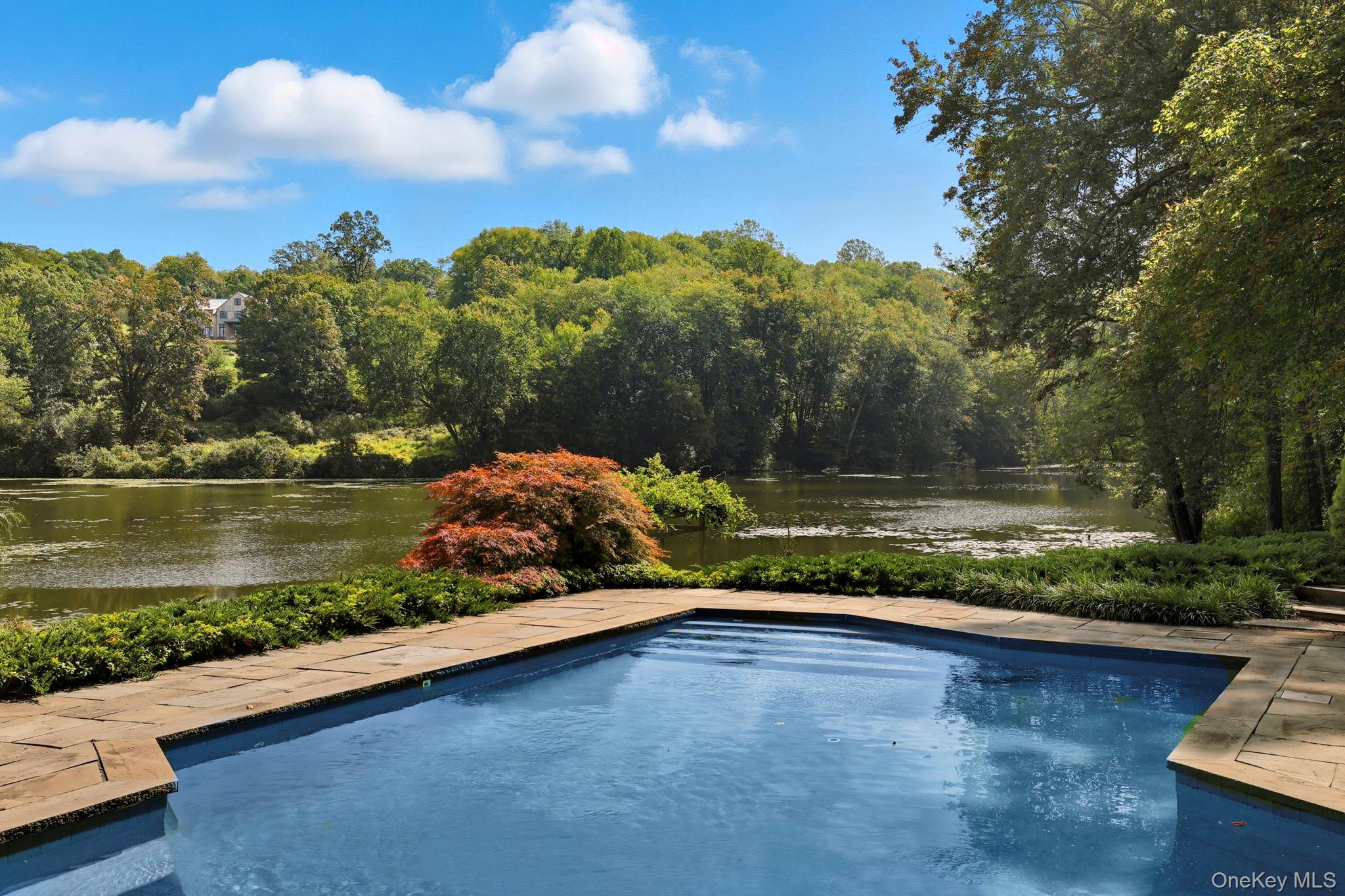 67 Banksville Road Armonk, NY 10504 - Photo 41 of 49 a view of a lake with a yard