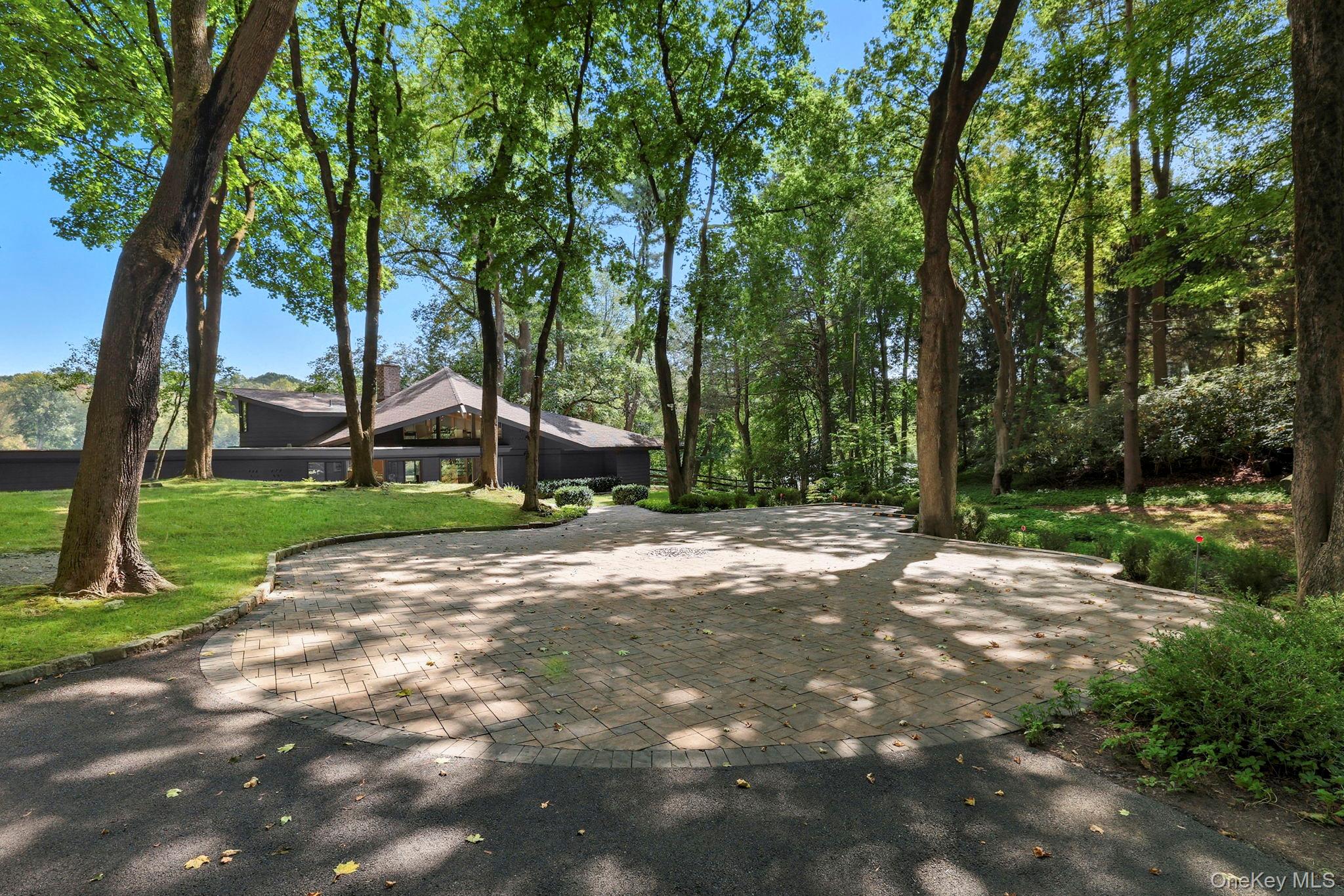 67 Banksville Road Armonk, NY 10504 - Photo 42 of 49 a view of a street with a building and trees in the background