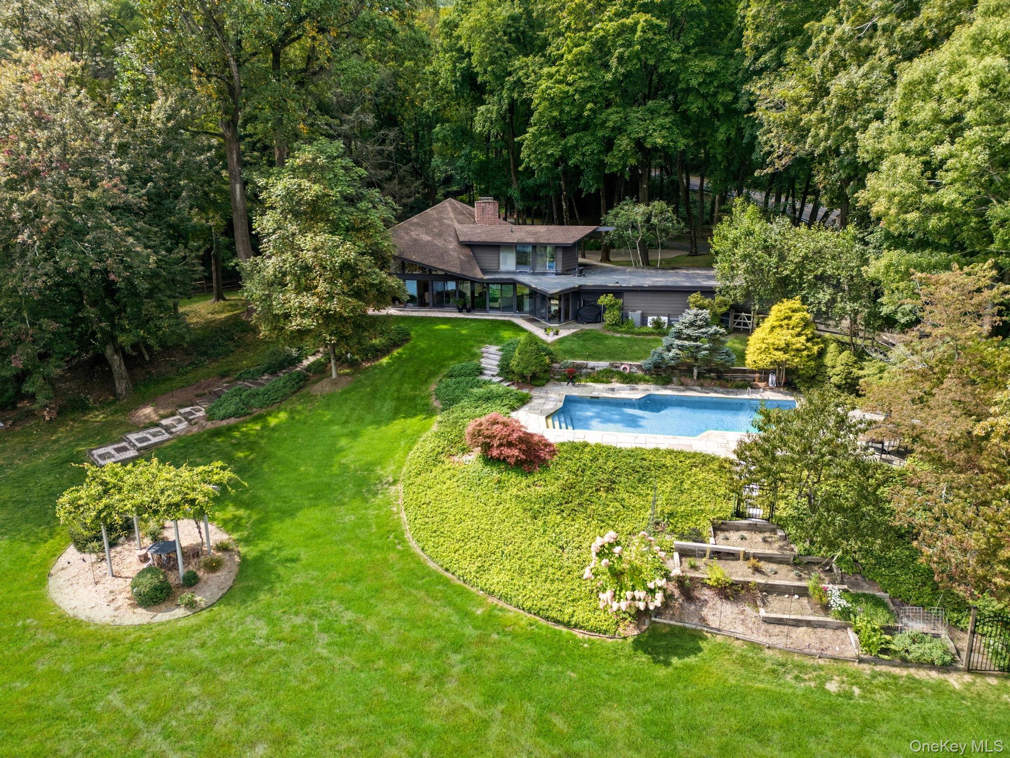 67 Banksville Road Armonk, NY 10504 - Photo 44 of 49 a view of a swimming pool with a garden