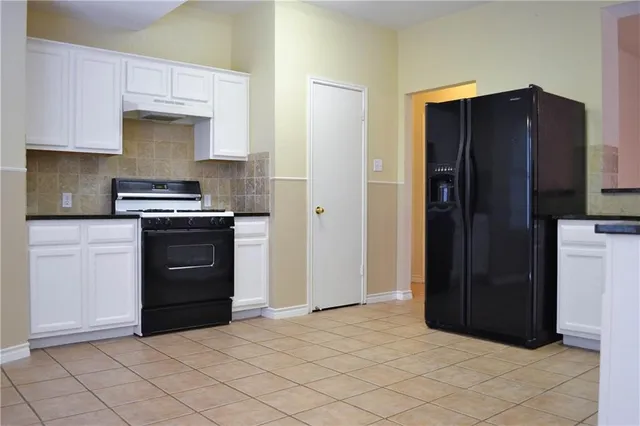 a kitchen with a refrigerator and a stove