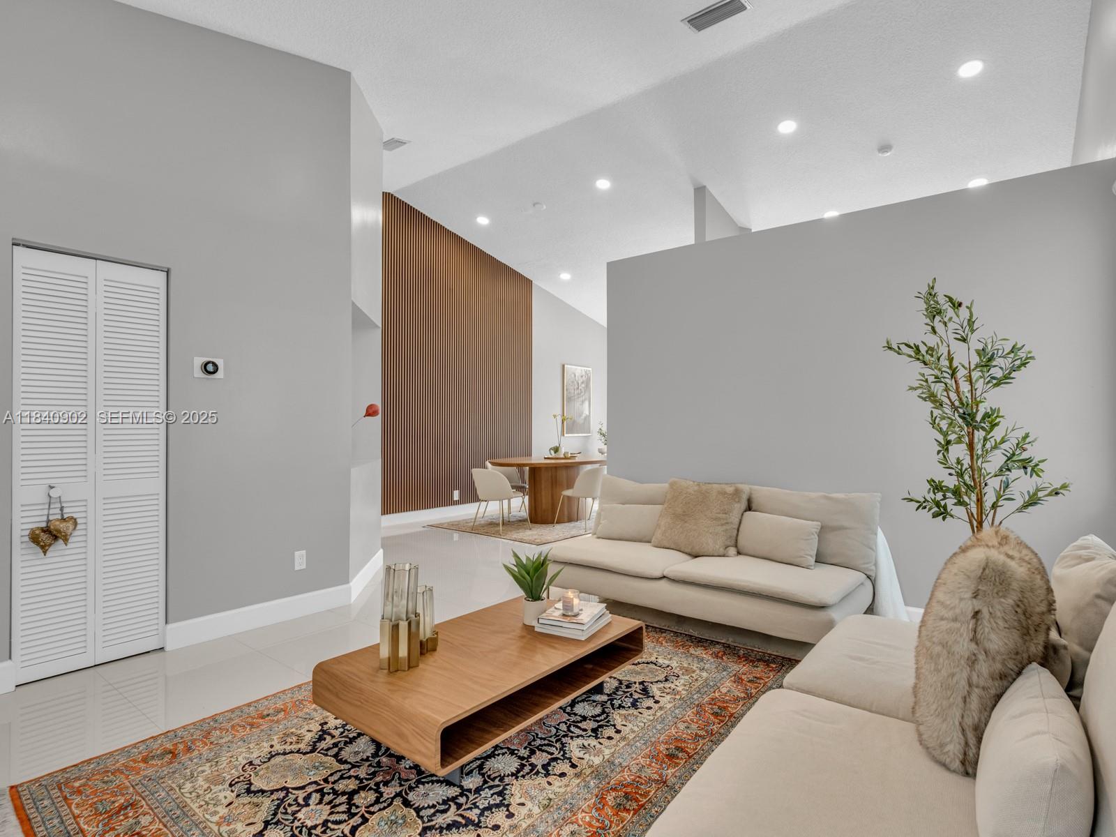 933 Falling Water Road Weston, FL 33326 - Photo 11 of 58 a living room with furniture and wooden floor